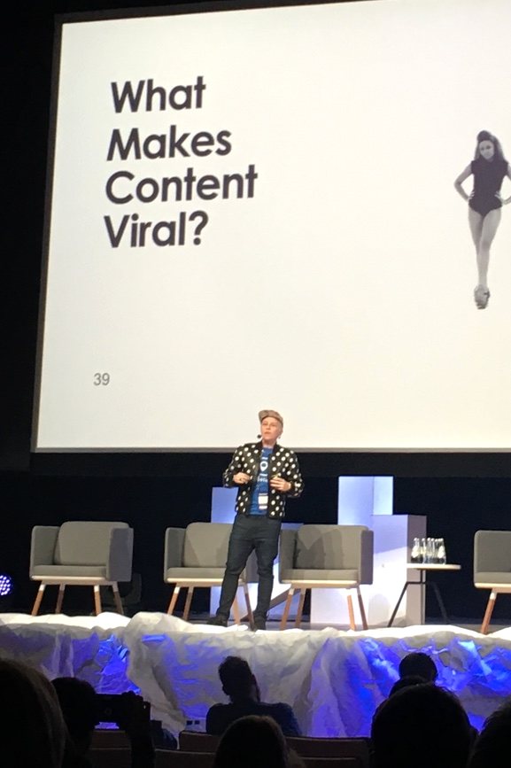 Lauren Proctor speaking in front of a slide that reads What Makes Content Viral?